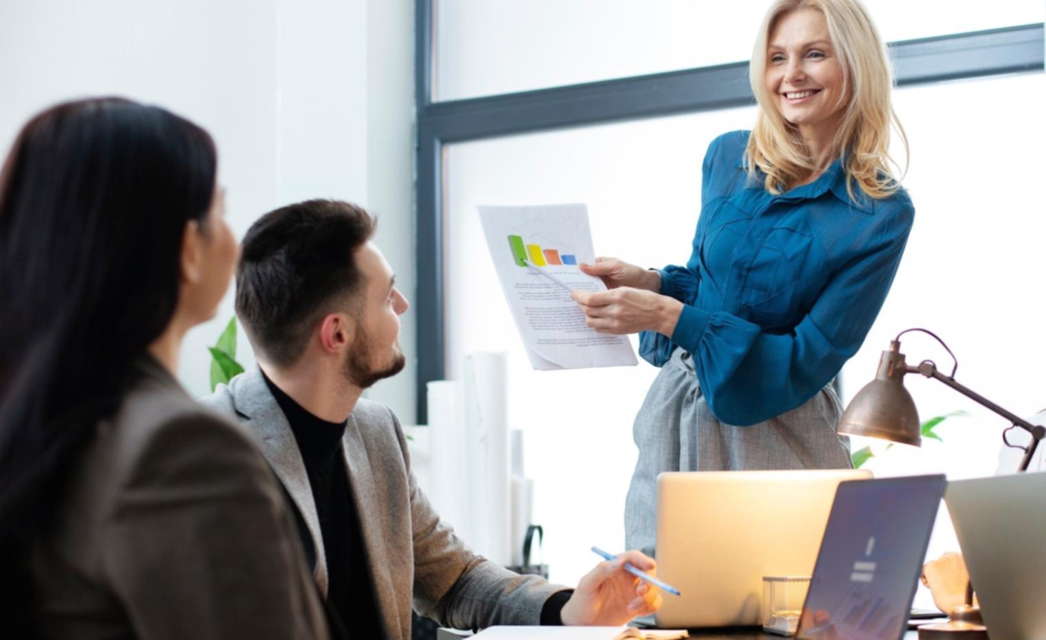 Modern office environment with financial analysts working on trend analysis projects